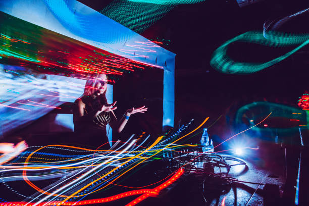 istock Young Woman DJ Dancing on Stage During Performance 910434346
