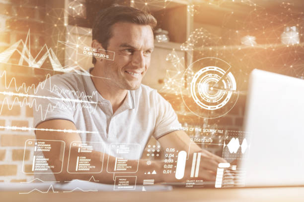 istock Cheerful smiling man using his laptop at home 910435374