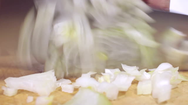 Slicing the onion on wooden bord