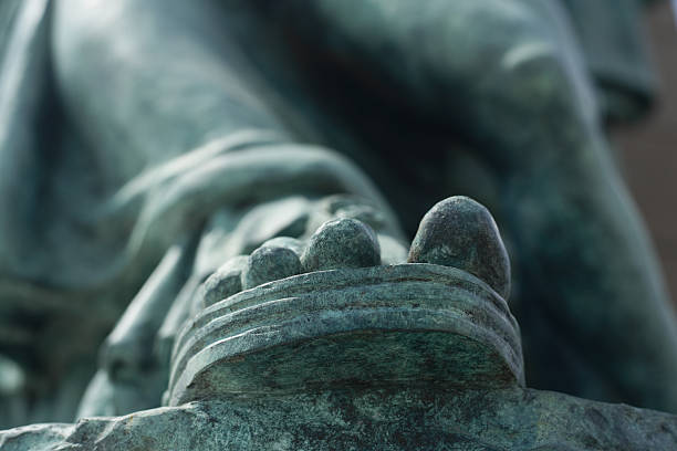 Greenish Sandled Foot of a Statue stock photo