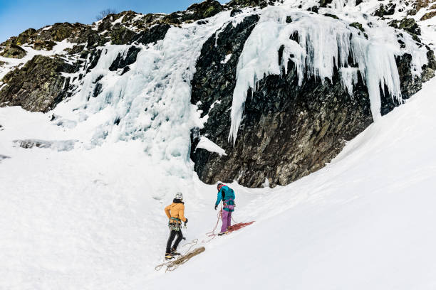 istock Woman and man preparing for ice climbing in the Pyrenees 910439584