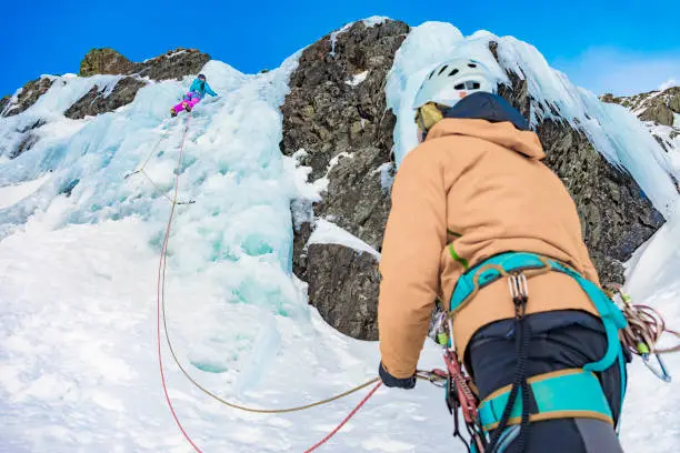 Photo of Man and woman ice climbing in the Pyrenees