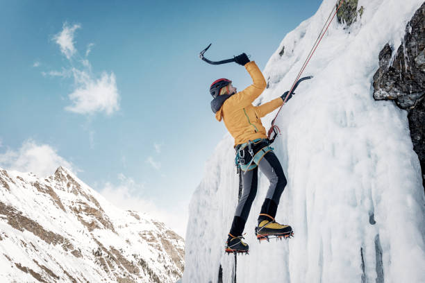istock Ice climber climbing frozen waterfall in the Pyrenees 910439658