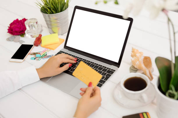 istock Person holding credit card in front of computer 910439728