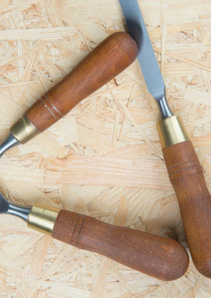 istock chisels on a wooden background 910439790
