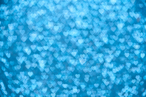 Valentine's Day Concept: Blue Sparklng Defocused Romantic Background of Lights Hearts..