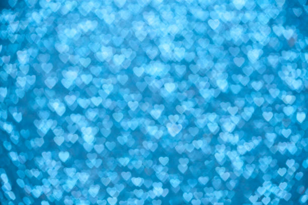 Cтоковое фото Сини�й сверкающий defocused огни сердца фон