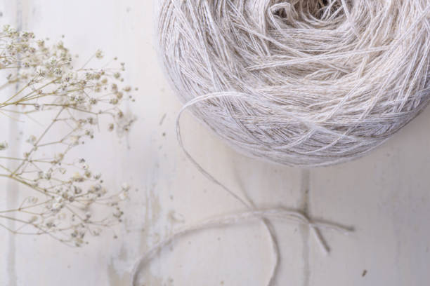 Precious luxury hank of linen on a white table with white flowers