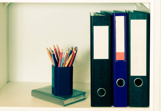 istock Office shelf with folders and pencil holder. 910450098