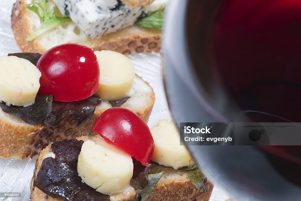Sandwiches on plate and glass of red wine  Antipasto Stock Photo