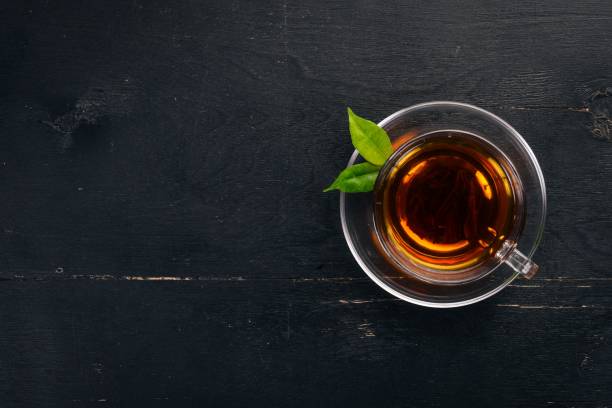 istock A cup of black tea on a wooden background. Top view. Copy space. 910456590