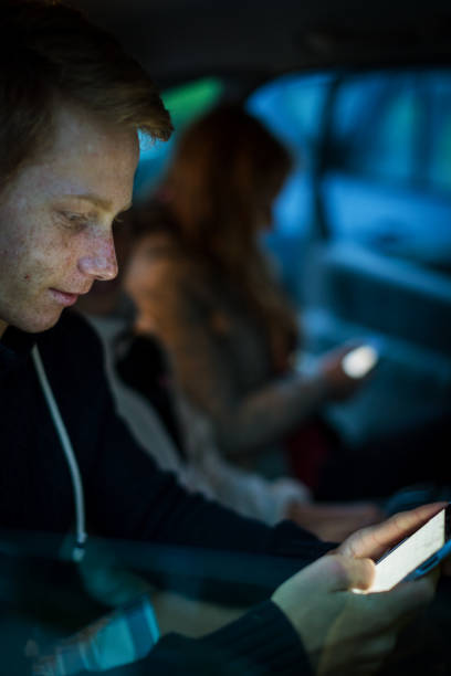 istock Brothers and sister together watching mobile phone 910456702