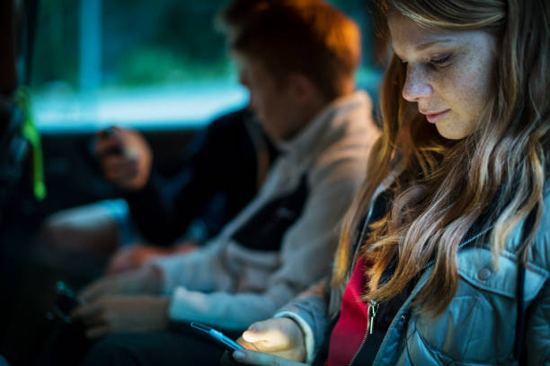 Brothers and sister together watching mobile phone