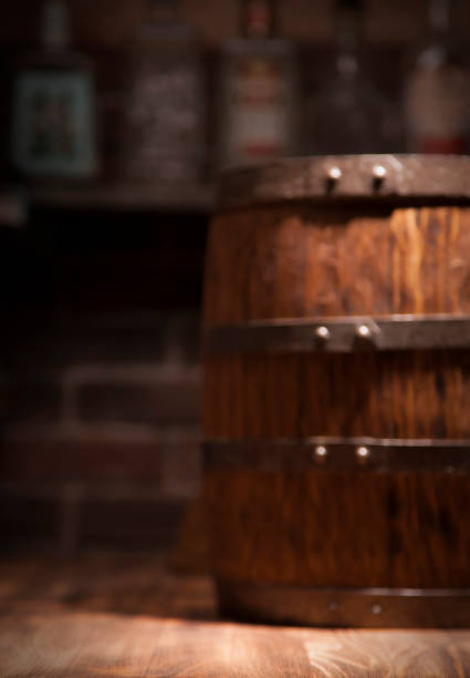 istock Barrel of whiskey on rustic table.blur bar background 910457506