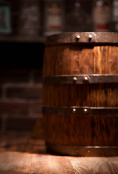 istock Barrel of whiskey on rustic table.blur bar background 910457548
