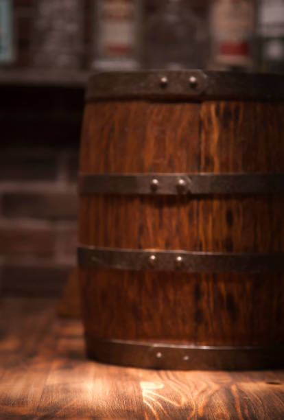istock Barrel of whiskey on rustic table.blur bar background 910457640