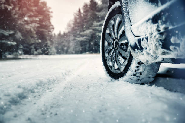 Car tires on winter road Car tires on winter road covered with snow. Vehicle on snowy way in the morning at snowfall car snow stock pictures, royalty-free photos & images