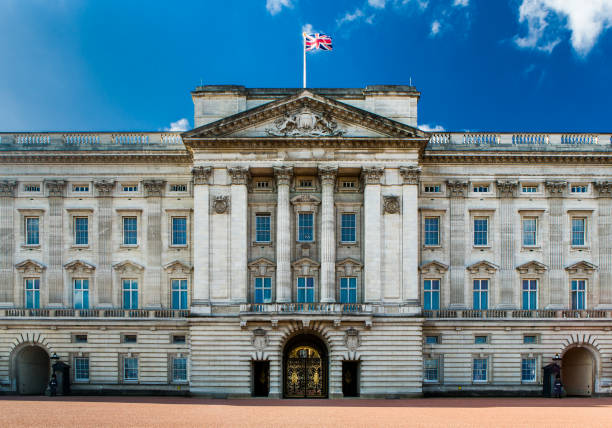 Buckingham Palace Facade. The facade of Buckingham Palace with the Union Flag flying against a clear blue sky. buckingham palace photos stock pictures, royalty-free photos & images