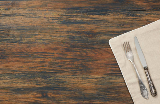 istock Knife, fork and towel on wood table 910468132