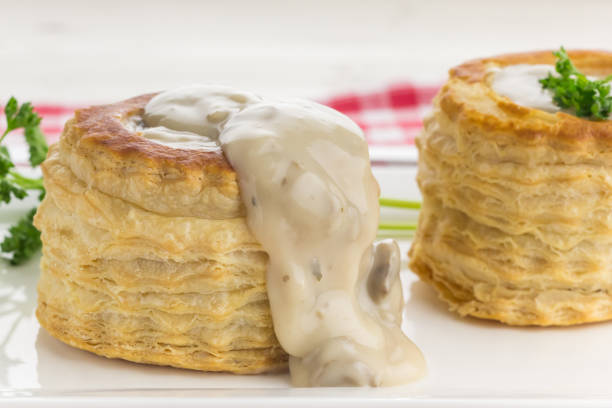 mushroom ragout running out of a freshly baked vol-au-vent - vol au vent imagens e fotografias de stock