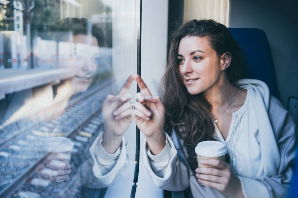 istock Young beautiful woman enjoys her coffee during the train ride. 910468970