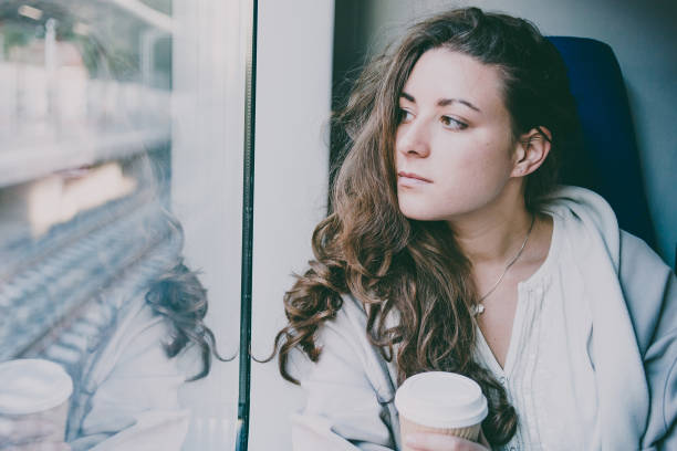istock Young beautiful woman enjoys her coffee during the train ride. 910469074