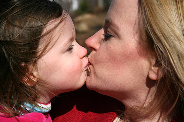 istock Mother and Daughter kissing 91047097