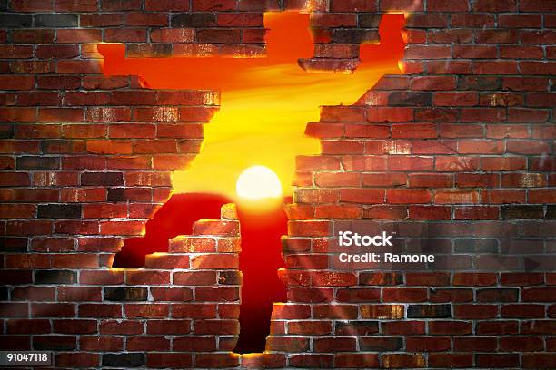 A Personshaped Hole In A Brick Wall With The Sun Setting Stock Photo - Download Image Now