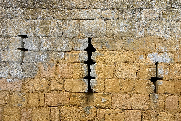 Carved stone blocks in the stone wall of a church.
