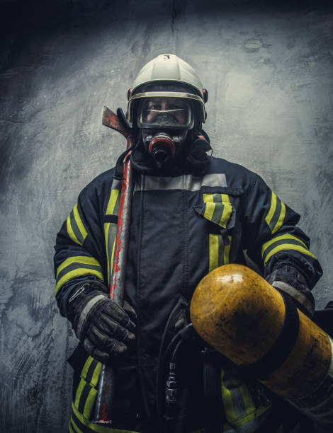 istock Rescue firefighter in safe helmet and uniform. 910475004
