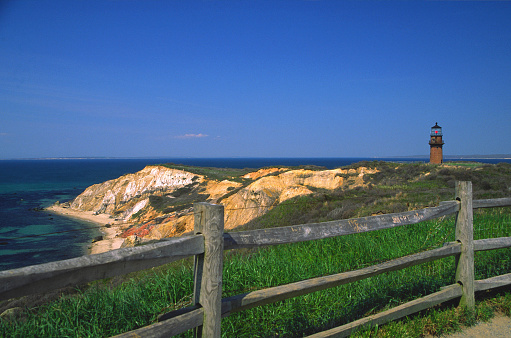 Gay Head Lighthouse and the Gay head Cliffs in the small town of Aquinnah, Massachusetts. Photo taken of the lush spring colors along the mile-long expanse of the Aquinnah Cliffs.  Martha's Vineyard is a New england destination full of beautiful beaches spectacular views, and quaint villages,