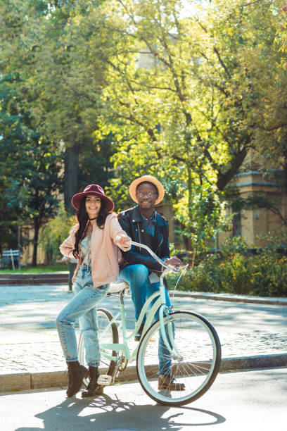 istock couple standing together with bicycle 910481592
