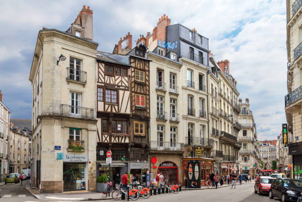 Cityscape of Nantes Beautiful cityscape view of the generic architecture of the houses with shops in Nantes, France, with people in the streets on July 29, 2014 nantes stock pictures, royalty-free photos & images