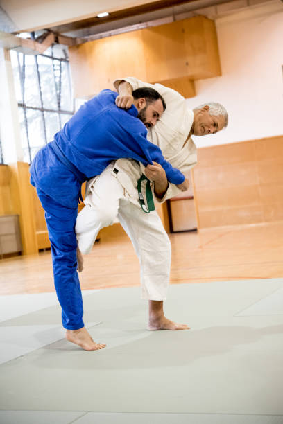 istock Senior Man Using Judo Technique to Force his Adversary to the Ground 910484524
