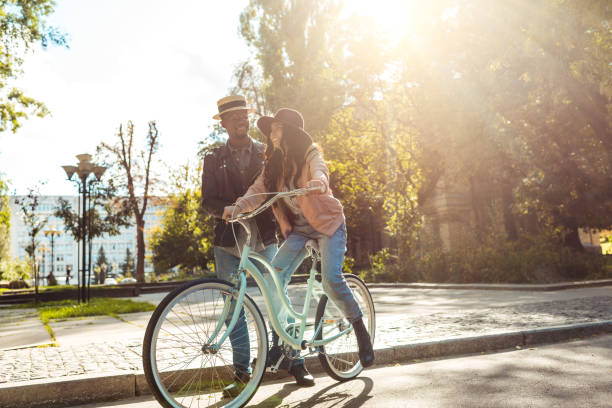 istock Boyfriend helping girlfriend riding bike 910484764