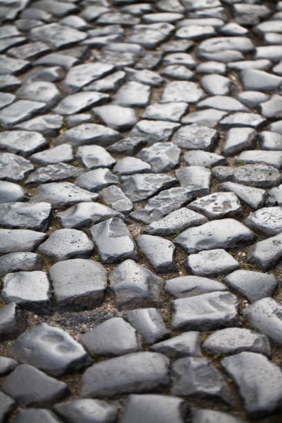 istock paving - background of old cobblestone pavement close-up. 910484936
