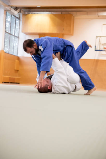 istock Adult Judoist Performing Circle Throw Technique 910485004