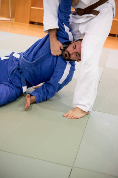 istock Judo Fighter Being Held on the Ground 910485014