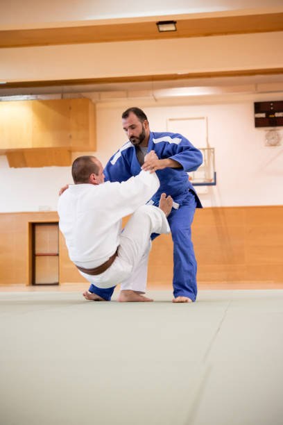 istock Adult Judoist Performing Circle Throw Technique 910485016