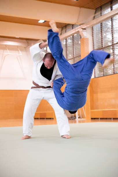 istock Judo Fighter Shoulder Wheel Throwing his Opponent 910485020