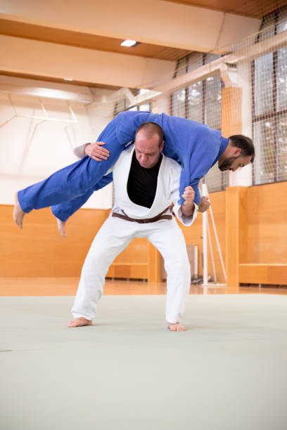 istock Judo Fighter Shoulder Wheel Throwing his Opponent 910485022