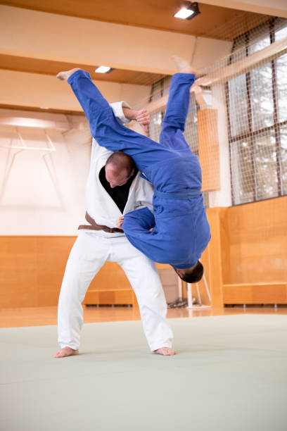 istock Judo Fighter Shoulder Wheel Throwing his Opponent 910485034