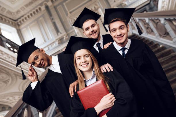 istock Students in mantles are happy that they finish their studies at the university. 910488414