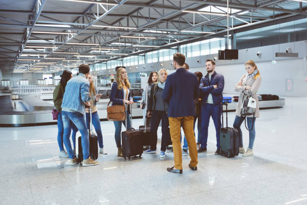 istock Group of passengers standing at airport lounge 910488714