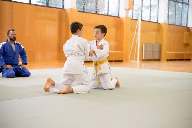 Two boys practicing judo.