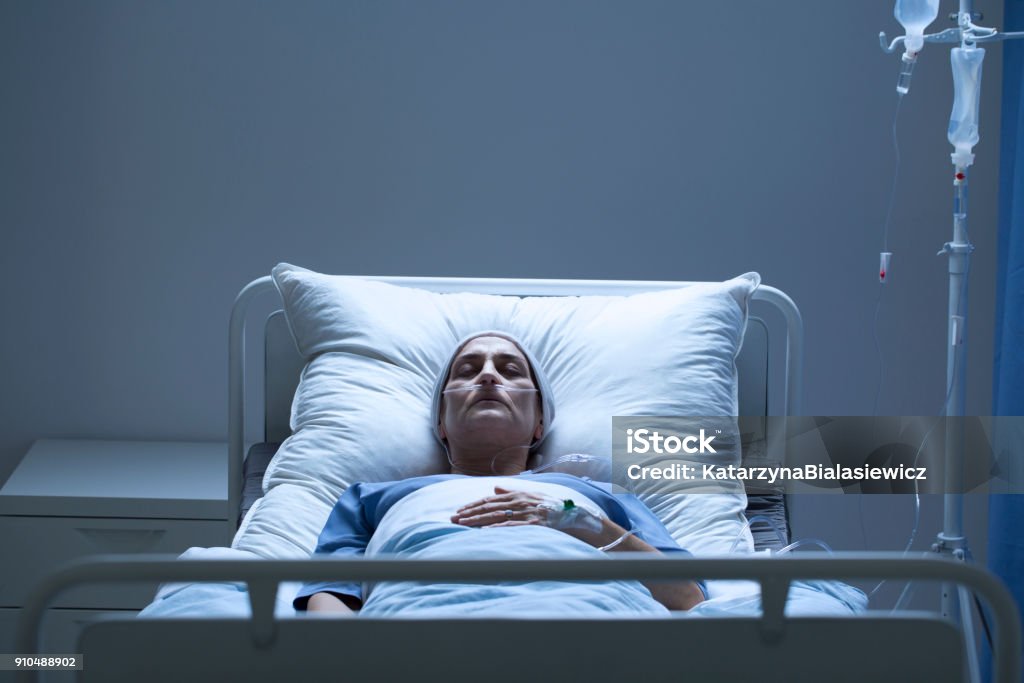 Weak woman during chemotherapy Weak woman with cancer dying alone during chemotherapy Patient Stock Photo