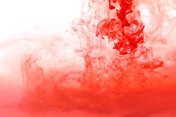 red paint in water . color paint pouring in water.splashes of red colour