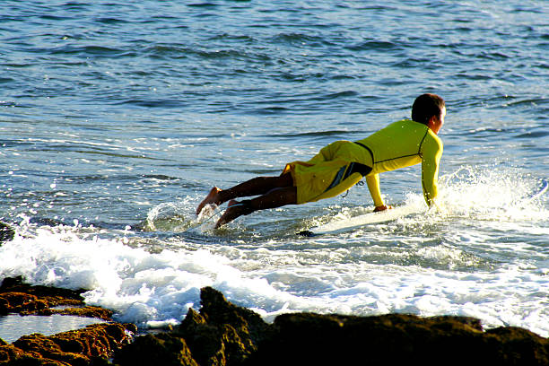 Jumping onto the Surfboard stock photo