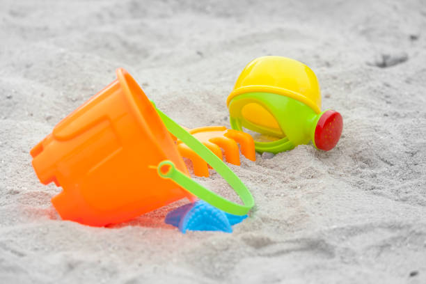istock Set of color plastic toys on a sand 910493510