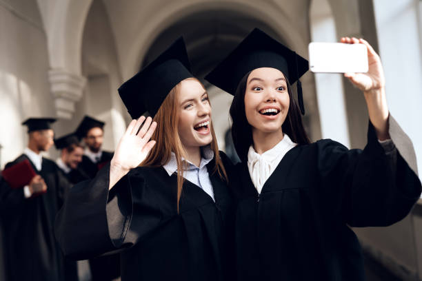 istock Two girls in black mantles are making selfie. 910493606